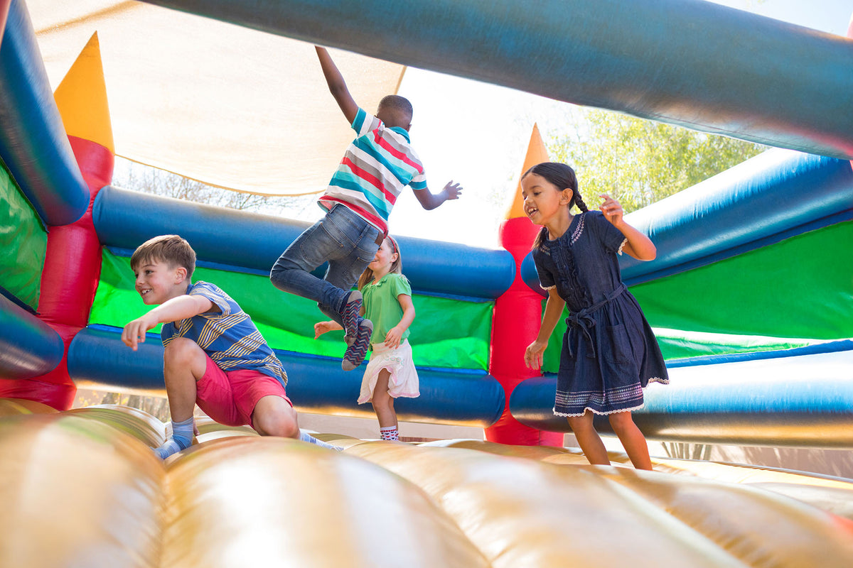 kids playing in an inflatable bounce house